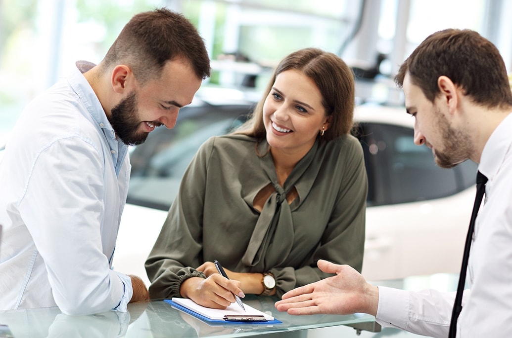 salesperson at desk with customers